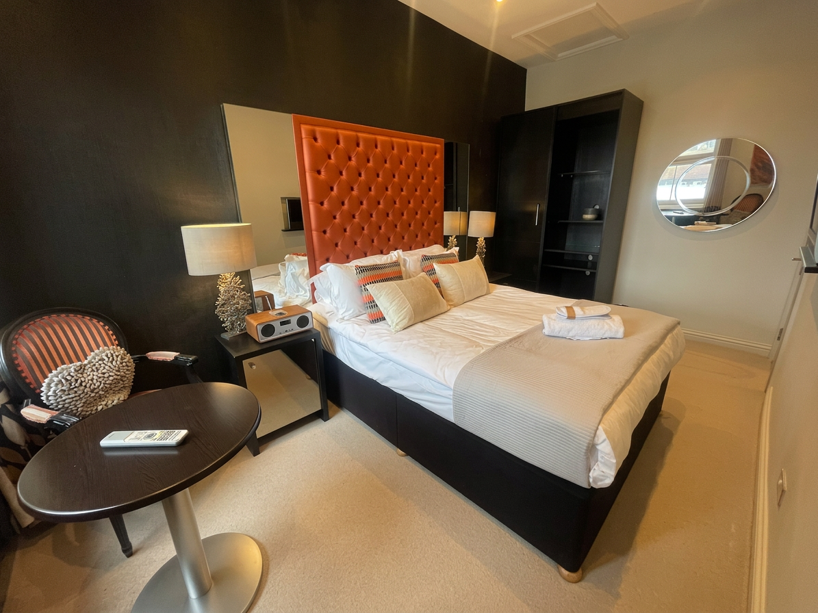 Hastings House Bedroom 6 — wide angle showing bed, wardrobe and round table