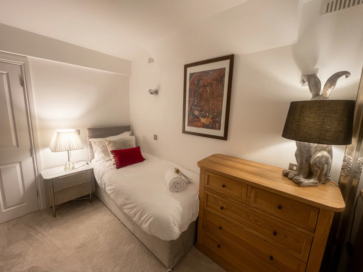 Hastings House Bedroom 9 — cosy single bed with hare lamp and botanical artwork