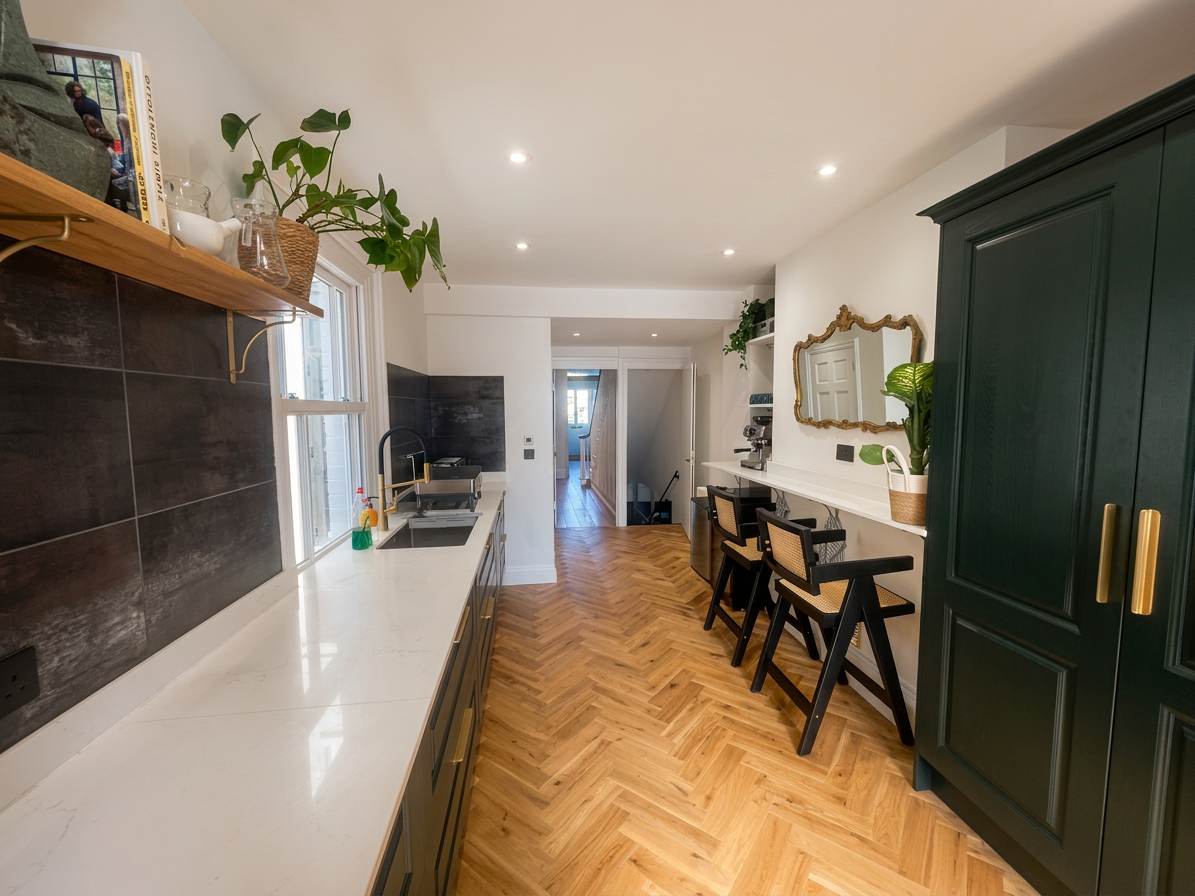 Hastings House kitchen from second angle with green cabinetry and herringbone floor