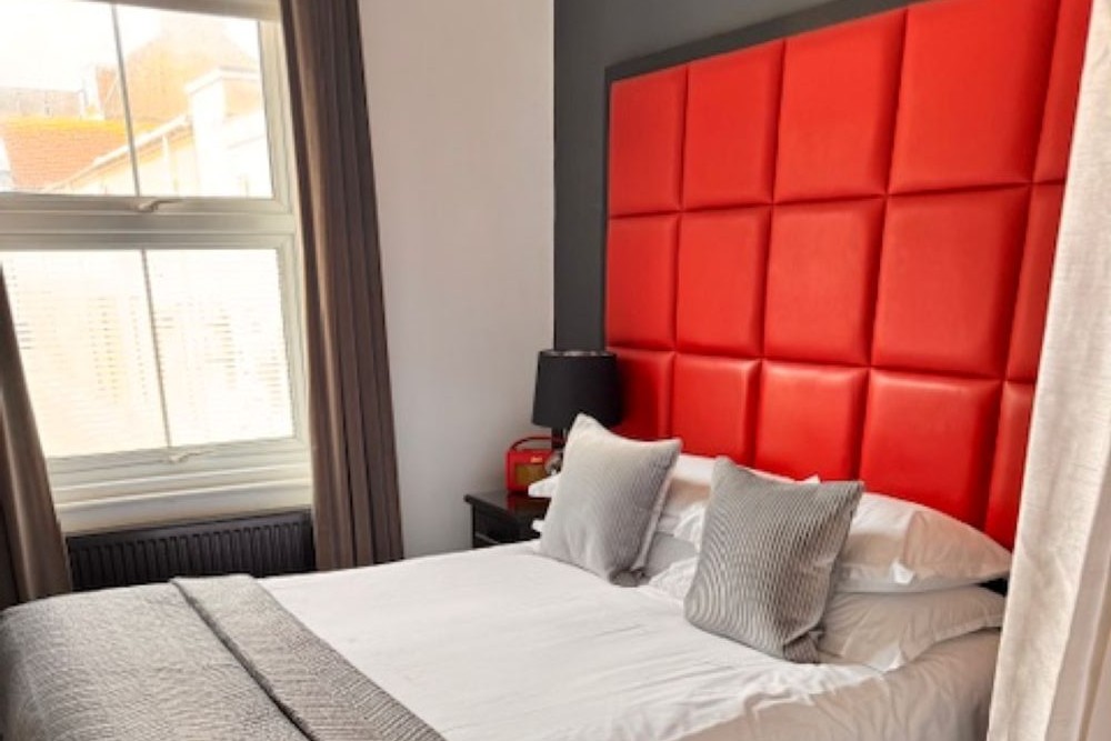 Hastings House Bedroom 1 — red headboard